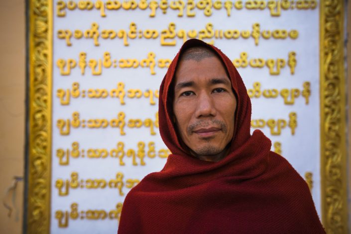 RANGOON, MYANMAR – JANUARY 16 : A monk poses in front of Burmese
