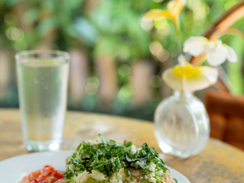 Fresh breakfast toast with produce at bright outdoor cafe