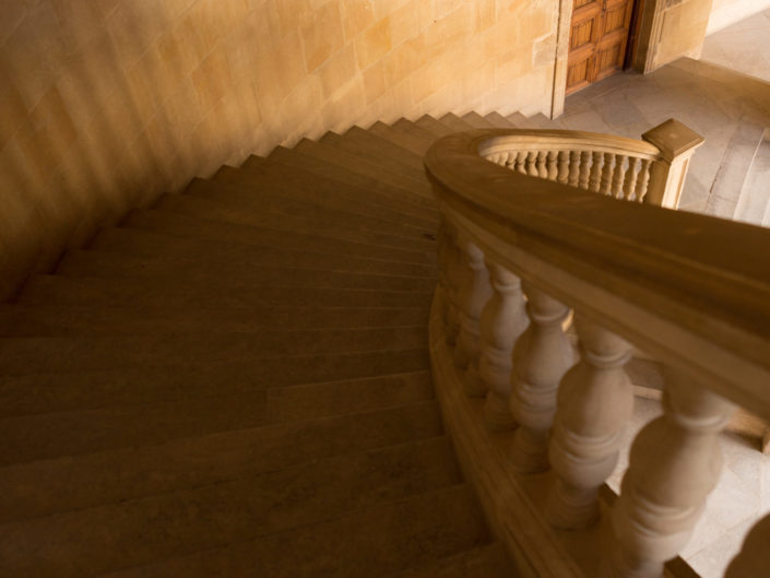 Curved stone staircase leading to wooden door