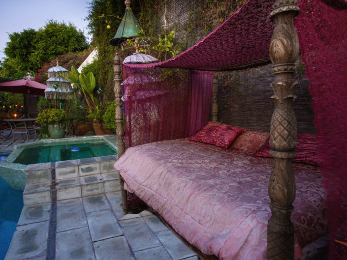 Pink Bed Next to Outdoor Pool