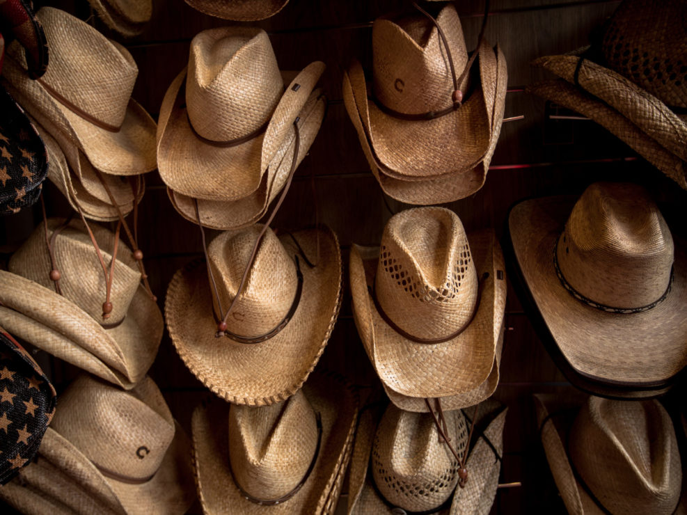 Rack of straw cowboy hats