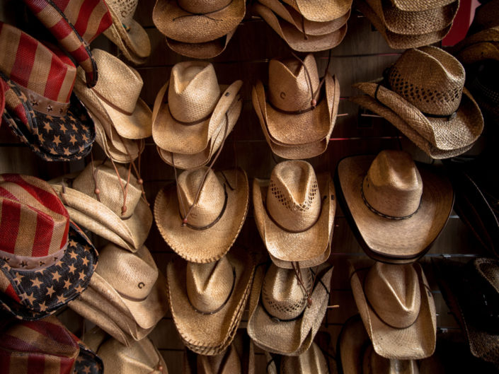 Rack of straw cowboy hats