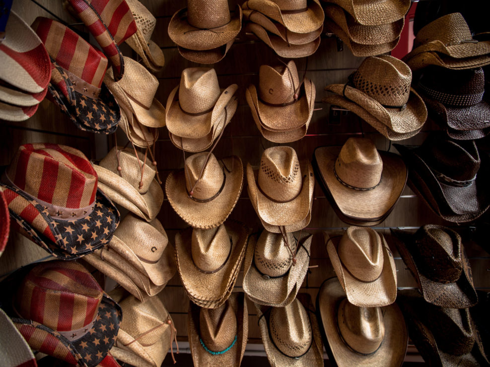 Rack of straw cowboy hats