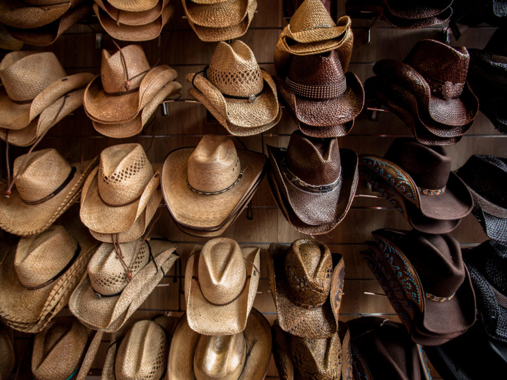 Rack of straw cowboy hats