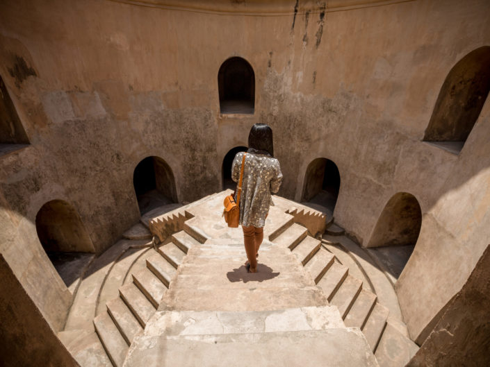 Woman on elevated walkway in Taman Sari underground Mosque, Yogy