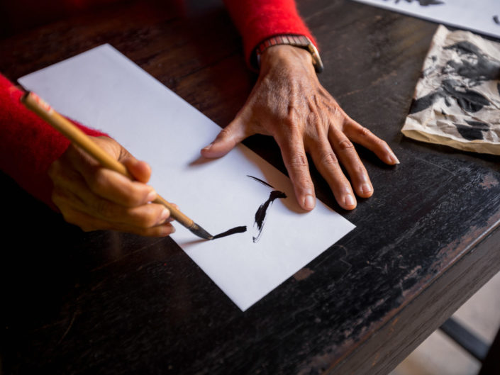 Hands of traditional calligrapher in Hoi An, Vietnam