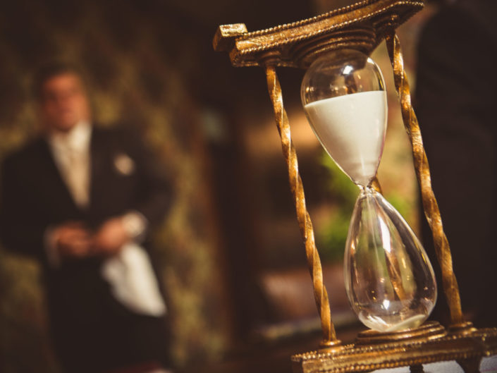 Vintage hourglass and man in tuxedo