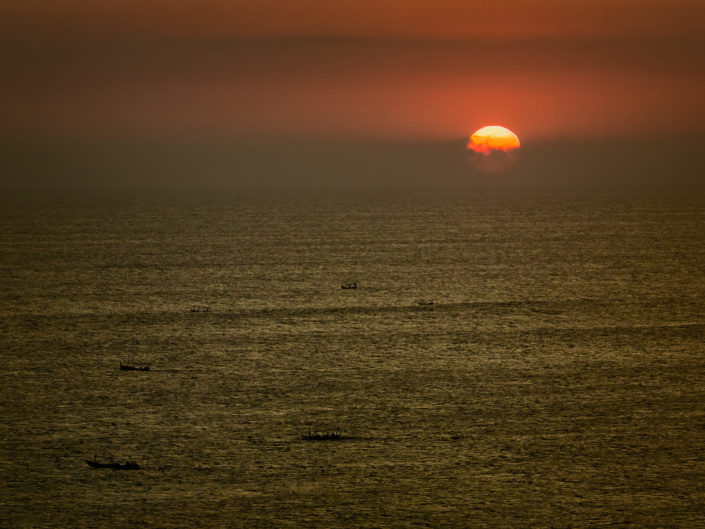 Boat silhouettes at sunset