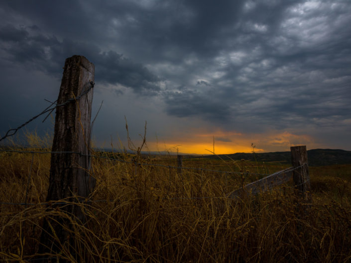 Fence in a Field at Sunset