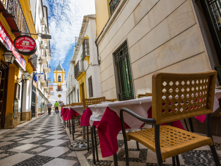 RONDA, SPAIN – JULY 28: Pristine alleyway with cafe tables in Ro