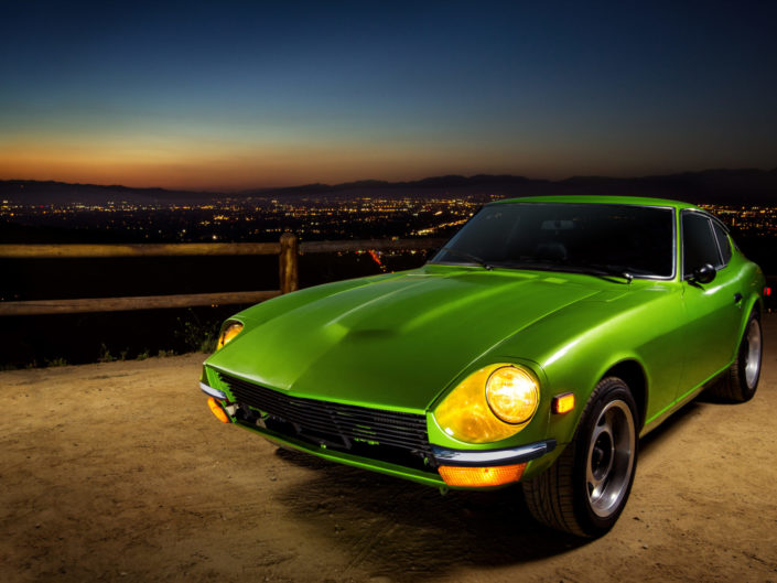 Vintage green sports car at sunset