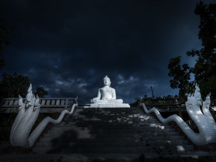 White buddha statue at night – Phra That Maeyen temple, Thailand