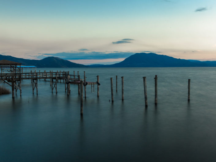 Old dock in front of mountains